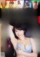 a japanese woman in a blue bra top is posing for the camera