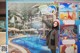 A woman standing in front of a sign advertising a water park.