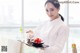 A woman holding a tray with food on it.