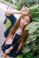 A woman in a school uniform posing for a picture.