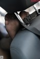 A close up of a person's hand holding a seat belt.