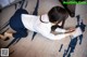 A woman sitting on the floor using a tablet computer.