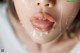 A close up of a woman's face covered in cream.