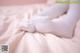 A pair of white socks sitting on top of a bed.