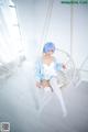 A woman sitting on a swing in a room.