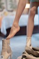 A close up of a woman's legs and boots.