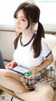 A woman sitting on a chair holding a Nintendo Switch.