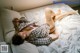 A woman laying on a bed with her legs up.