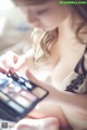 A woman in lingerie looking at her makeup palette.