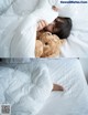 A little girl laying in bed with a teddy bear.