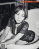 A black and white photo of a woman sitting in a bathtub.