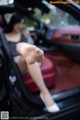 A woman sitting in the back seat of a car with her feet up.