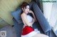 a woman in a santa claus outfit sitting on a couch