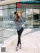 A woman standing in front of a coffee shop.