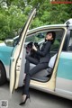 A woman sitting in the driver's seat of a car.