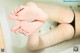 A woman's feet in a bathtub with water on them.