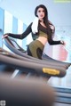 A woman in a black top and leggings on a treadmill.