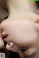 A close up of a woman kissing another woman's face.