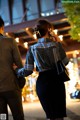 A man and a woman walking down the street at night.