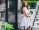 a woman in a white dress standing on some steps