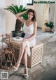 A woman sitting on top of a wooden box.