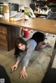 A woman laying on the floor in an office.