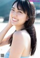 A woman with long black hair smiling at the camera.