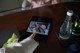 A person using a tablet computer on a table.