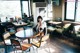 A woman sitting at a table in a restaurant.