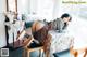 A woman laying on top of a table next to a chair.