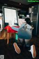 A woman kneeling on the floor in front of a menu.