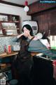 A woman in an apron standing in a kitchen.