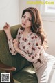 a woman sitting on top of a green couch