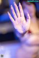 A woman's hand with water droplets on it. 