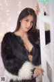 A woman in a black and white fur coat posing for a picture.